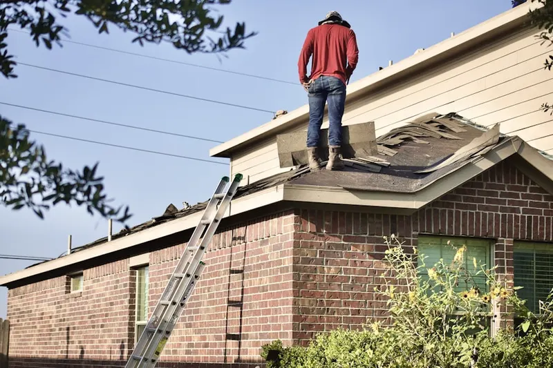 Professional roofer working on a residential roof in Coventry Crossing